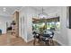 Charming breakfast nook with views of the outdoor space, complemented by a stylish light fixture and fireplace at 633 Hart Lake Dr, Winter Haven, FL 33884