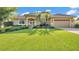 Beautiful home featuring mature landscaping, a well-manicured lawn and a two-car garage at 633 Hart Lake Dr, Winter Haven, FL 33884