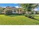 Charming home featuring mature landscaping, a well-manicured lawn, and a covered front entry at 633 Hart Lake Dr, Winter Haven, FL 33884