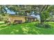 Charming single-story home with a well-manicured lawn, mature trees, and lush landscaping at 633 Hart Lake Dr, Winter Haven, FL 33884