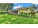 Beautiful single-story home with mature trees, well-manicured lawn, and manicured garden beds at 633 Hart Lake Dr, Winter Haven, FL 33884