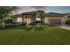 Beautiful home featuring mature landscaping, a well-manicured lawn and a two-car garage at 633 Hart Lake Dr, Winter Haven, FL 33884