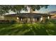 Beautiful home featuring a well-manicured lawn, mature landscaping, screened lanai and shade trees at 633 Hart Lake Dr, Winter Haven, FL 33884