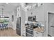 Well-lit kitchen area with stainless steel appliances, granite countertops, adjacent to a cozy breakfast nook with large window at 633 Hart Lake Dr, Winter Haven, FL 33884
