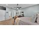 Calm main bedroom features soft lighting, a ceiling fan, a walk-in closet, and an ensuite bathroom at 633 Hart Lake Dr, Winter Haven, FL 33884