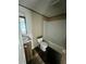 Bathroom featuring a sink, toilet, shower-tub combo, and wood-look flooring at 711 Whispering Pines Dr, Auburndale, FL 33823