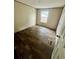 Empty bedroom with wood-look flooring and a window for natural light at 711 Whispering Pines Dr, Auburndale, FL 33823