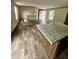 Kitchen island with granite countertop and modern wood-look flooring at 711 Whispering Pines Dr, Auburndale, FL 33823