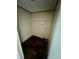 Compact laundry room features wood floors, a shelf, and hookups for a washer and dryer at 711 Whispering Pines Dr, Auburndale, FL 33823