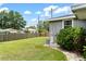 Spacious backyard with well-maintained lawn and mature trees at 819 Glendale St, Lakeland, FL 33803