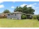 View of the home's rear exterior showcasing the large, well-manicured backyard at 819 Glendale St, Lakeland, FL 33803
