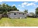 The home has a well-maintained backyard with a grassy lawn and a charming gray exterior at 819 Glendale St, Lakeland, FL 33803