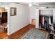 Bright bedroom with hardwood floors, a ceiling fan, and an open closet, offering simplicity and functionality at 819 Glendale St, Lakeland, FL 33803