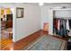 Bedroom with hardwood floors, an open closet, and simple decor, leading to an adjacent living space at 819 Glendale St, Lakeland, FL 33803