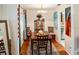 Charming dining area featuring hardwood floors, a decorative rug, and a view into the adjacent kitchen at 819 Glendale St, Lakeland, FL 33803