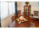 Close up of a dining room set with a hardwood table, upholstered chairs, and decorative accents at 819 Glendale St, Lakeland, FL 33803