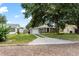 Charming home with an attached garage, a well-maintained lawn, and a welcoming brick-lined street at 819 Glendale St, Lakeland, FL 33803