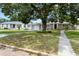 Quaint home featuring a well-kept lawn, a connecting garage, and a welcoming walkway to the front door at 819 Glendale St, Lakeland, FL 33803