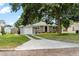 Charming home with attached garage and inviting walkway, complemented by a lush, green lawn at 819 Glendale St, Lakeland, FL 33803