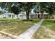 Charming home with attached garage, lush front lawn, and inviting walkway leading to the entrance at 819 Glendale St, Lakeland, FL 33803