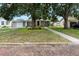 Cozy single story home with a detached garage and mature trees shading the front yard at 819 Glendale St, Lakeland, FL 33803