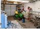 A spacious garage is equipped with storage shelves and includes a lawn mower for yard maintenance at 819 Glendale St, Lakeland, FL 33803