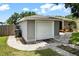 Exterior view of a single-car garage attached to the home, complemented by a walkway and green lawn at 819 Glendale St, Lakeland, FL 33803