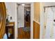 The hallway leads to a bathroom with wood paneling and to a bedroom with hardwood floors at 819 Glendale St, Lakeland, FL 33803