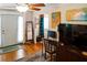 Comfortable living room featuring hardwood floors, a ceiling fan, and stylish decor at 819 Glendale St, Lakeland, FL 33803
