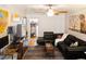 Comfortable living room featuring hardwood floors, a ceiling fan, and stylish decor at 819 Glendale St, Lakeland, FL 33803