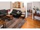 Comfortable living room featuring hardwood floors, a ceiling fan, and stylish decor at 819 Glendale St, Lakeland, FL 33803