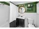 Well-lit bathroom with a shower-tub combination, a vanity with a sink, and a decorative mirror at 918 South Blvd, Lakeland, FL 33803