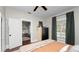 Cozy bedroom with a ceiling fan, window with green curtains, and a dining area seen through the open door at 918 South Blvd, Lakeland, FL 33803