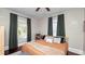 Bright bedroom features large windows with dark green curtains, a plush bed, and a built-in bookshelf at 918 South Blvd, Lakeland, FL 33803
