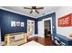 This blue Bedroom includes a cozy crib, a bookshelf, and white shiplap accent wall at 918 South Blvd, Lakeland, FL 33803