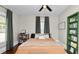 Comfortable bedroom featuring a ceiling fan, bed with pillows, bookshelf and green shelving at 918 South Blvd, Lakeland, FL 33803
