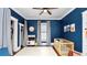 Blue Bedroom with a crib, play kitchen, and a white rug creates a playful yet serene atmosphere at 918 South Blvd, Lakeland, FL 33803