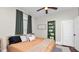 Cozy bedroom featuring natural light, comfortable bed, and decorative shelving at 918 South Blvd, Lakeland, FL 33803