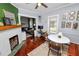 Cozy dining room adjacent to the living room, featuring a decorative fireplace and hardwood floors at 918 South Blvd, Lakeland, FL 33803