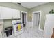 Efficient kitchen layout with white cabinets, stove and access to other areas of the home at 918 South Blvd, Lakeland, FL 33803