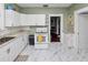 Well-lit kitchen showcasing white cabinets, stainless steel sink, granite countertops and modern appliances at 918 South Blvd, Lakeland, FL 33803