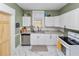 Charming kitchen featuring white cabinets, stainless steel appliances, and a bright, clean aesthetic at 918 South Blvd, Lakeland, FL 33803
