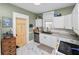 Cozy kitchen boasting white cabinets, granite countertops, subway tile backsplash, and stainless steel appliances at 918 South Blvd, Lakeland, FL 33803