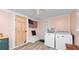 Functional laundry room with a washer and dryer, plus convenient storage with a bench and drawers at 918 South Blvd, Lakeland, FL 33803