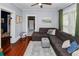 Comfortable living room with a large sectional sofa, classic hardwood floors, and ample natural light at 918 South Blvd, Lakeland, FL 33803