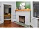 View of a traditional fireplace in the living room, enhanced by hardwood flooring and natural light at 918 South Blvd, Lakeland, FL 33803