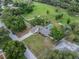 Aerial view showcasing the property's location, large lot, swimming pool, and proximity to lush green surroundings at 929 Hammock Shade Dr, Lakeland, FL 33809