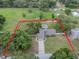 Aerial view of the property, highlighting its expansive lot, fenced yard, and swimming pool, showcasing privacy at 929 Hammock Shade Dr, Lakeland, FL 33809
