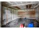 View of the unfinished basement, with block walls, a wood paneled wall, and a concrete floor at 929 Hammock Shade Dr, Lakeland, FL 33809