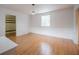 Bright bedroom features hardwood floors, wainscoting, and a large window with natural light at 929 Hammock Shade Dr, Lakeland, FL 33809
